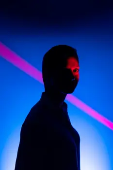 Female electrical engineer in lights on catwalk