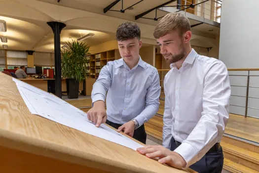Building services engineers discussing plans