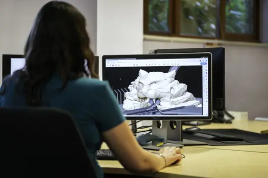 Female civil engineer designs theme park rides on a computer