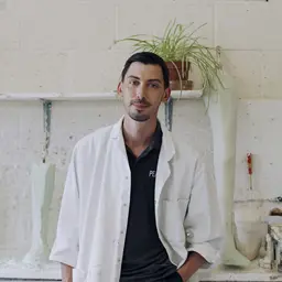 Male orthotics technician engineer stands in workshop