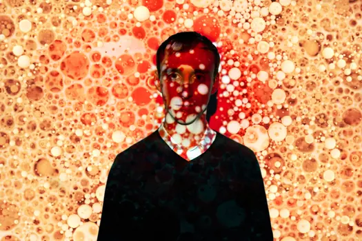 Male chemical engineer with projections of blood cells
