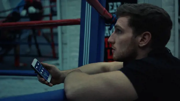 Male mechanical engineer uses software to monitor boxers performance in the boxing ring