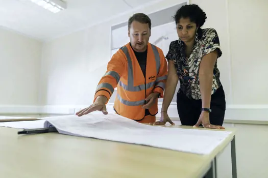  Female civil engineer discusses flood risk management with colleague 