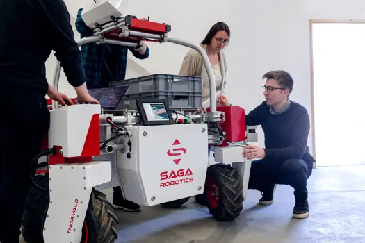 Mechanical engineers inspecting an agricultural robotic.