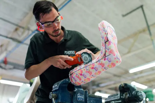 Male orthotics technician crafting a leg cast