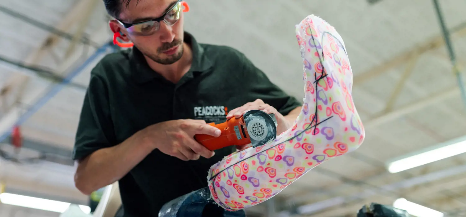 Male orthotics technician crafting a leg cast