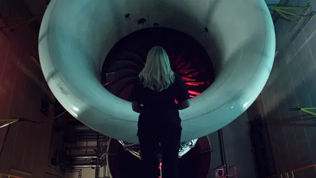 Female engineering production manager, next to an aircraft engine