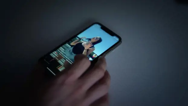 Music video on mobile phone screen