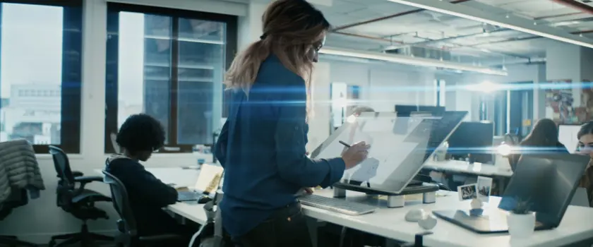 Female product design engineering sketching ideas on a large interactive screen