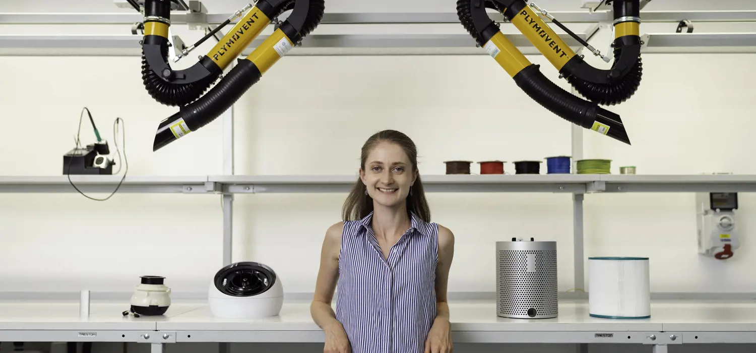 Female noise and acoustics engineer stands in workshop