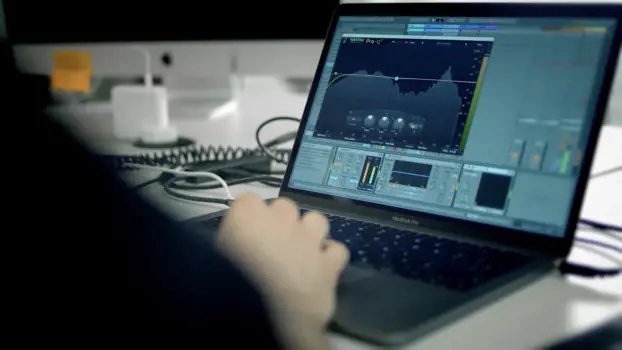 Software engineer codes on laptop