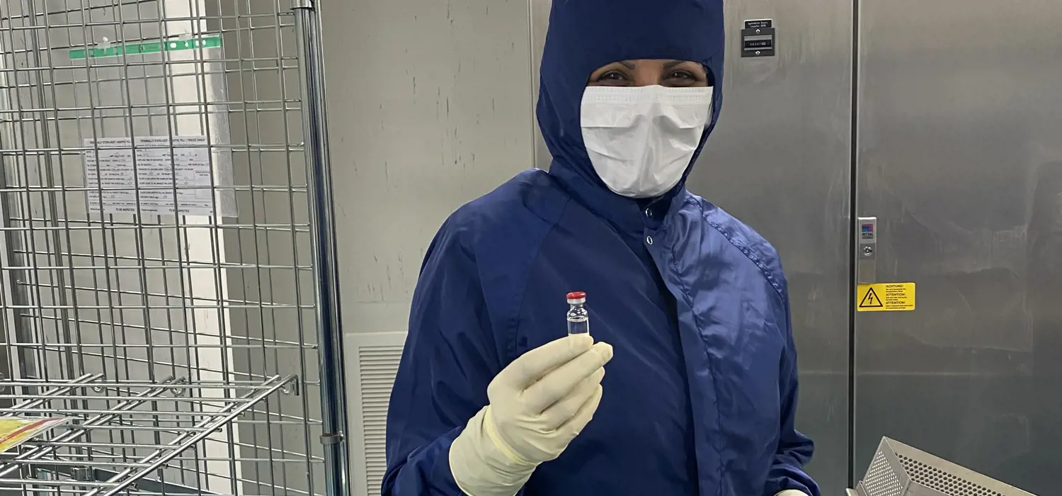 A team member at the Wockhardt factory holding the manufactured vial of the AstraZeneca COVID-19 vaccine.