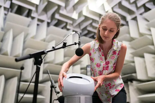 Noise and acoustics engineer tests product in anechoic chamber
