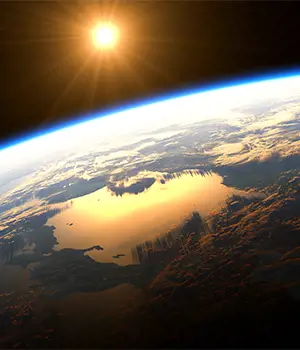 View of Earth from space glowing golden in the light of the sun